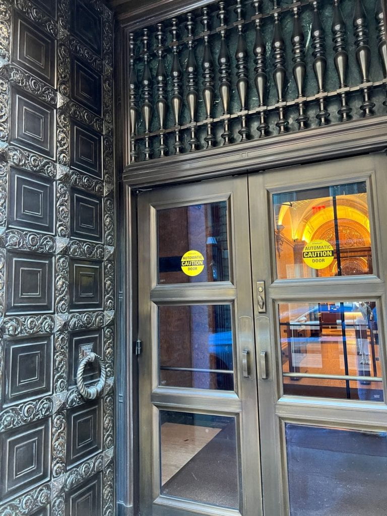 ornate entry way around metal doors with windows